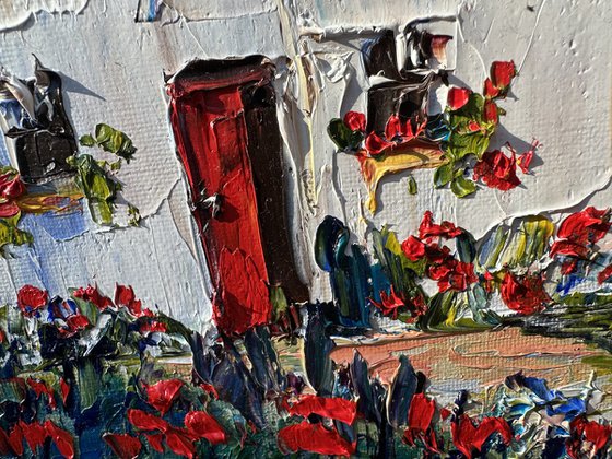 Old house with red flowers