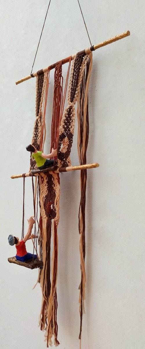 Figures working on the macrame wall hanging by Shweta  Mahajan