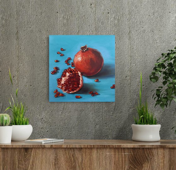 Ripe red pomegranates on turquoise - blue background still life 2