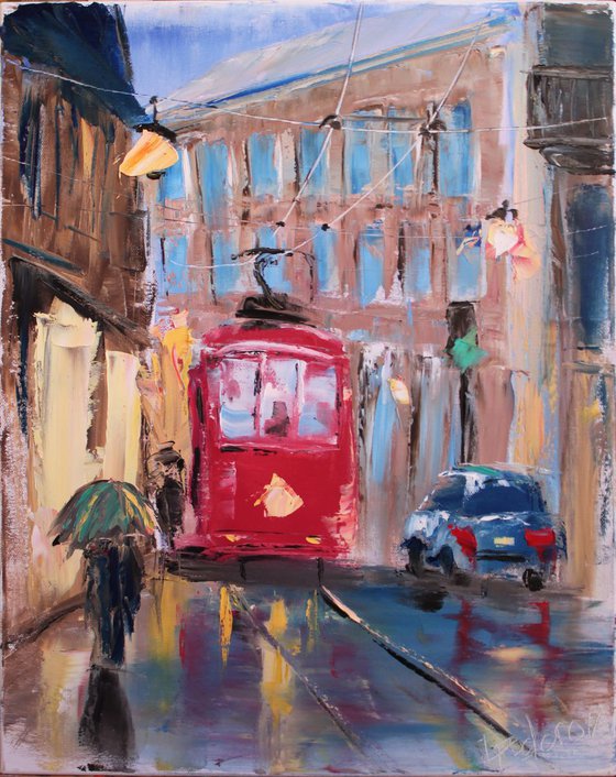 Rainy day in old city with red streetcar