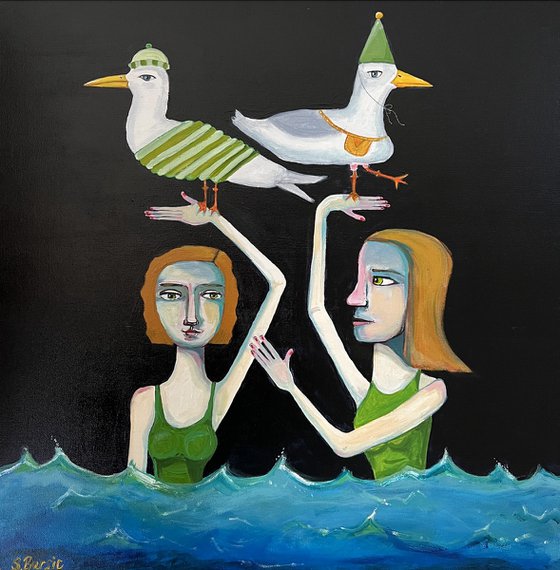 Ladies enjoying the sea with 2 seagulls