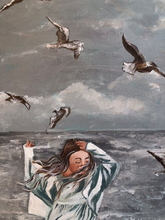 Girl and seagulls by the sea