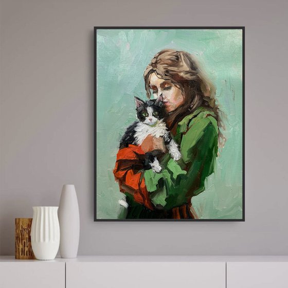 Girl in green dress with cat.