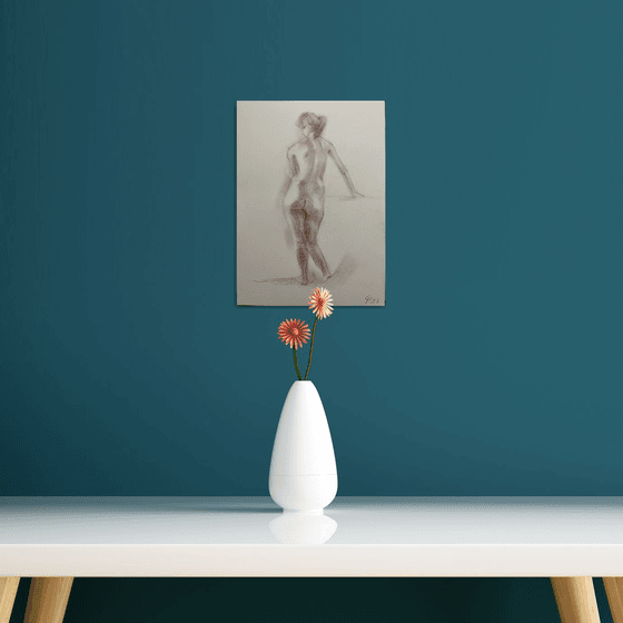 Nude female figure standing from behind