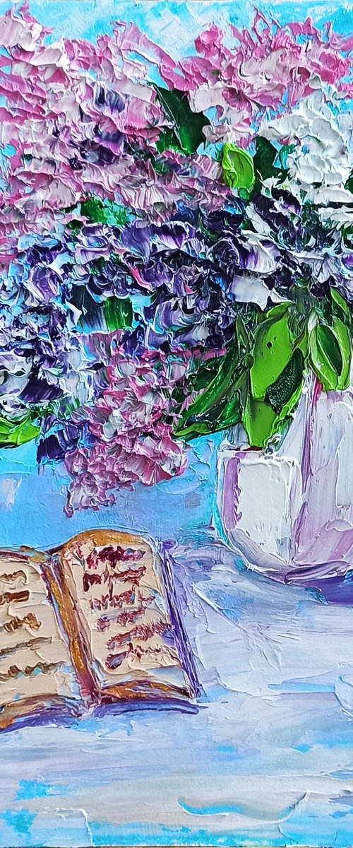 Lilac flowers and a book still life by Oksana Fedorova