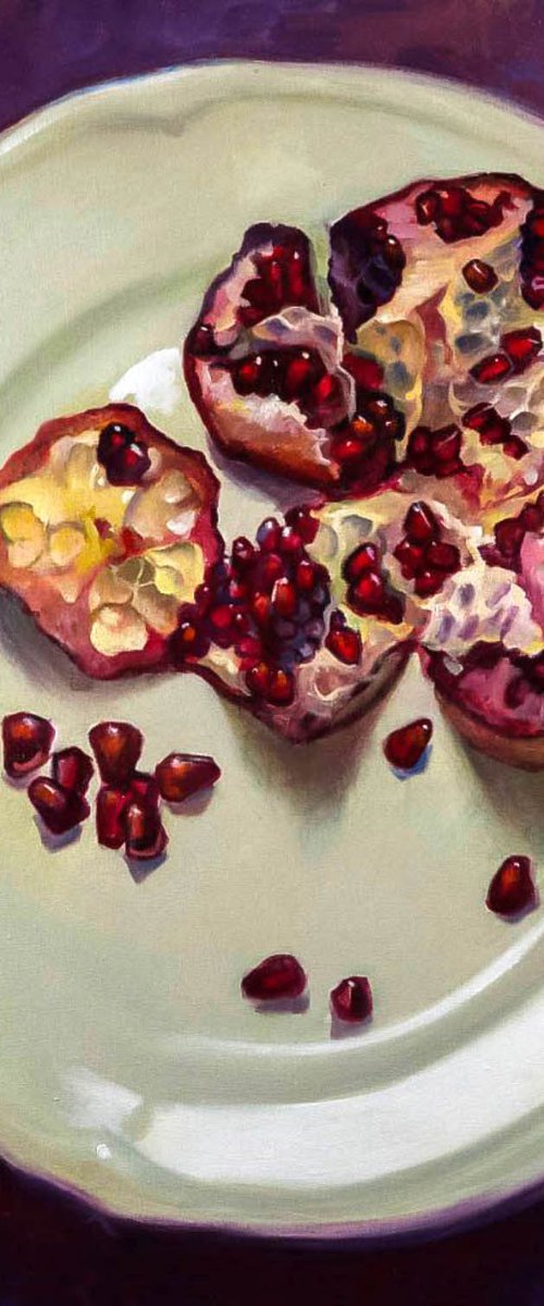 pomegranate on a white plate by Sergei Yatsenko