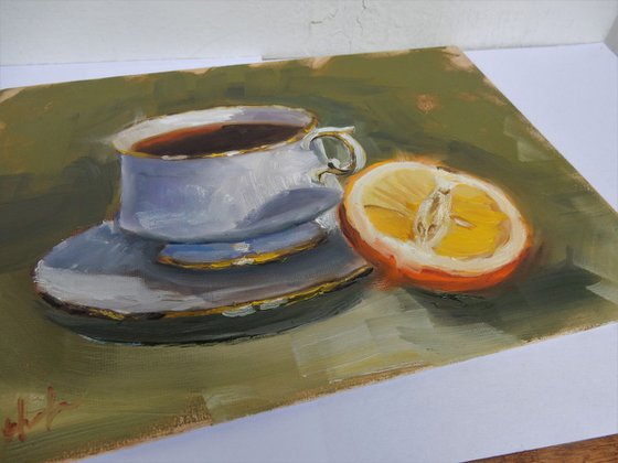 Teacup and orange. still life