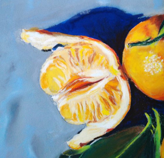 Three tangerines on blue