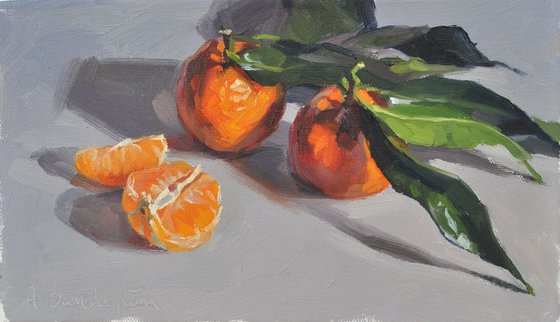 Clementines with leaves, grey background