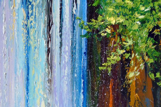 Mountain waterfall by the lake