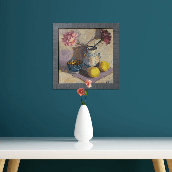 Lemons and flowers with a vase