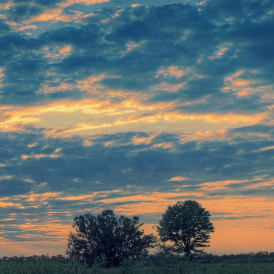 Flying clouds over the setting sun.