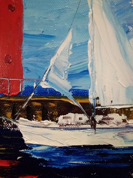 Sailing yacht and the red lighthouse
