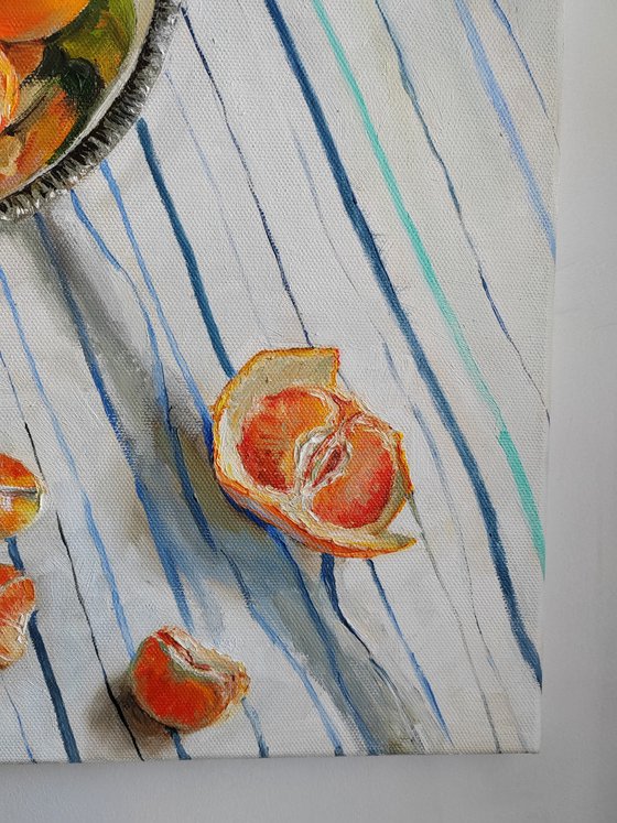 Clementines on stripen tablecloth