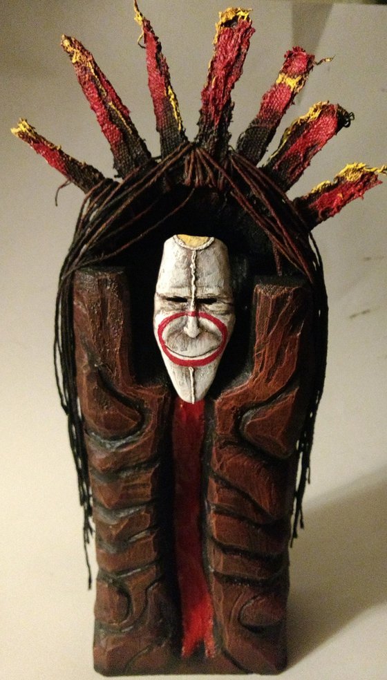 Mask of a smiling god. original sculpture