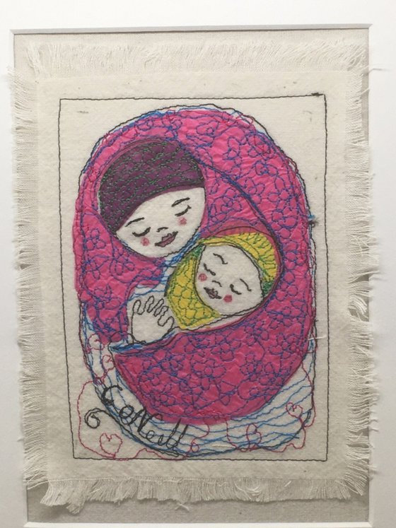 Mother and baby wrapped in a pink blanket.    Mixed media  Textile