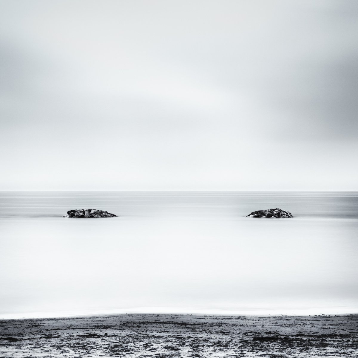 Two rocks emerging from the sea by Karim Carella