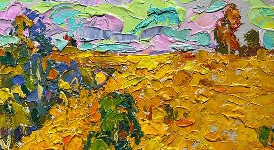 Golden field among trees