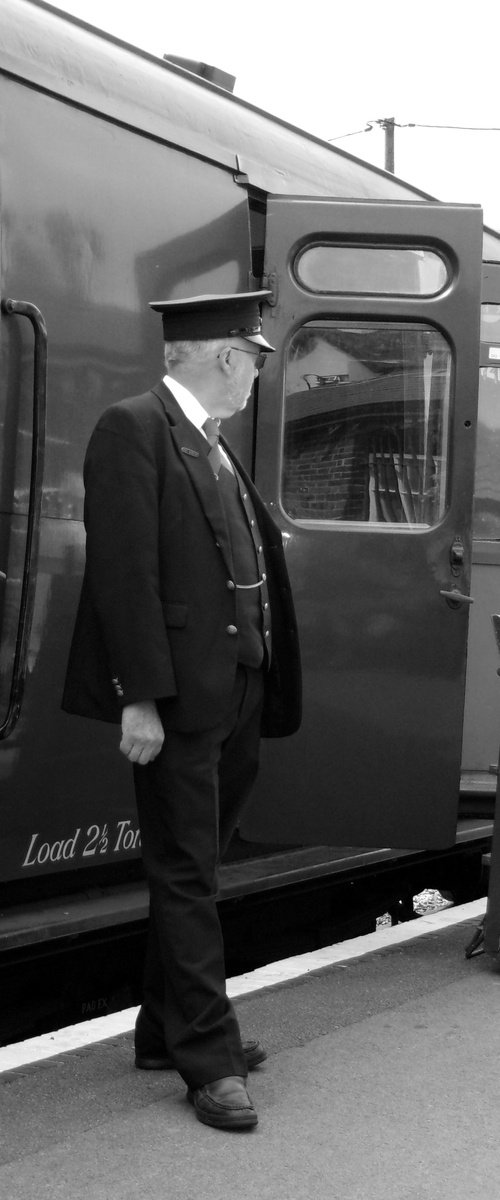 Station guard and steam train carriage by Tim Saunders