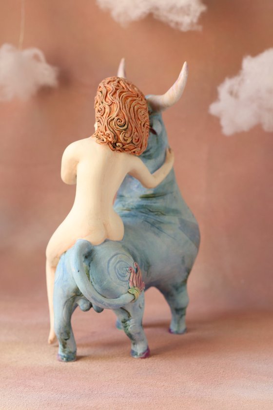 Riding your dreams. Girl on a blue ox