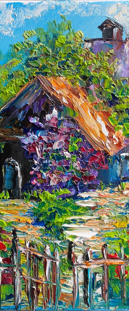 The flowering garden around a small house by Oksana Fedorova