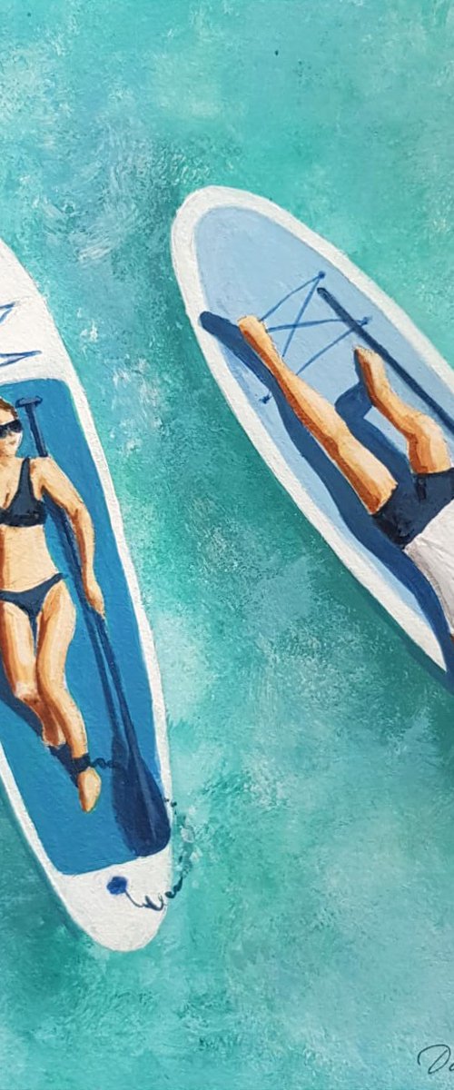 Couple on Sup boards by Daria Startseva