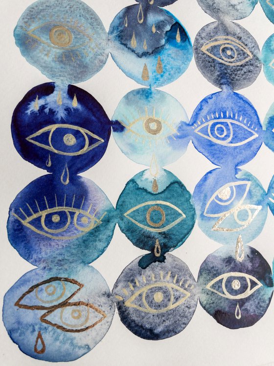 Gold leaf eyes on blue watercolor background