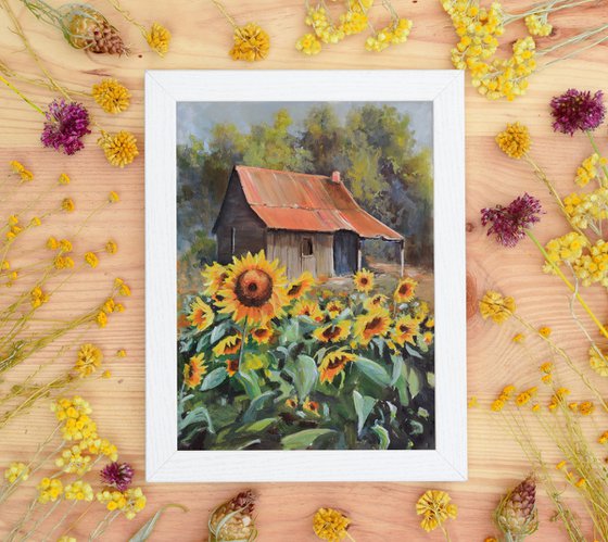 Old cabin with sunflower yard