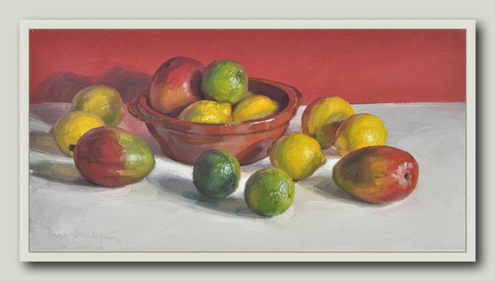 Mangos, lemons and limes, red background