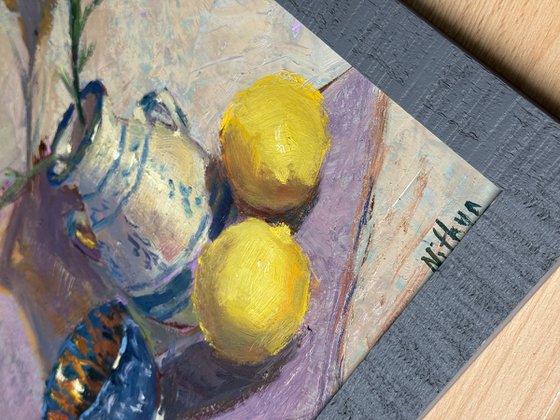 Lemons and flowers with a vase