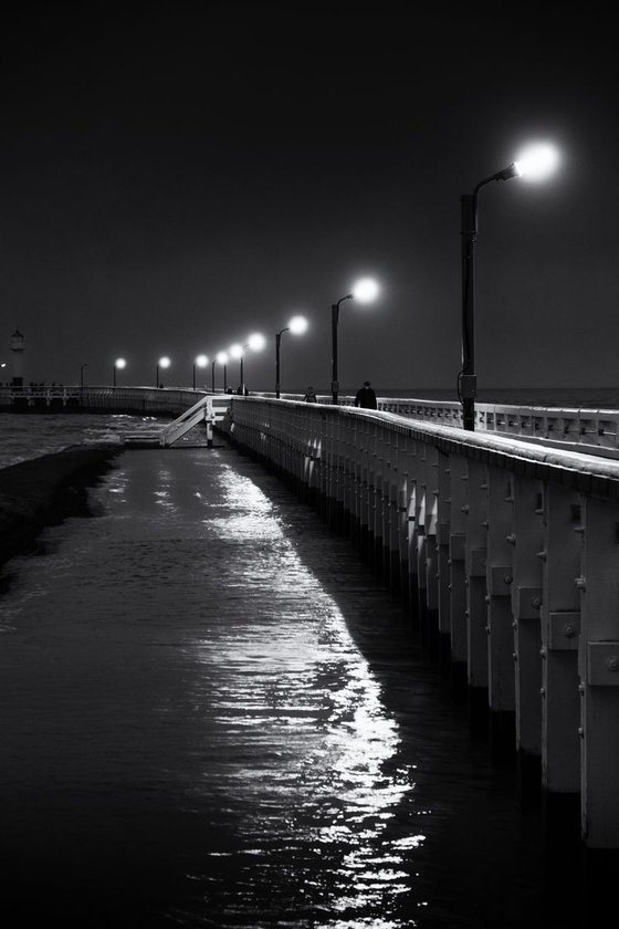 Lonesome walk along the winter pier