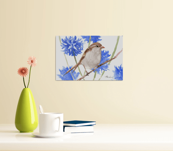 sparrow and blue flowers