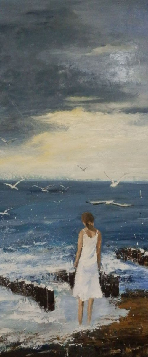 Seagulls and a lonely woman at seashore by Maria Karalyos