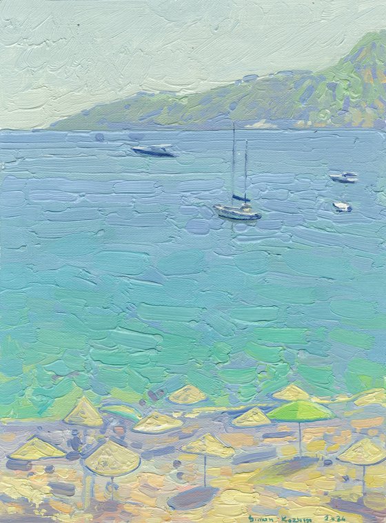 Yachts and umbrellas on the beach