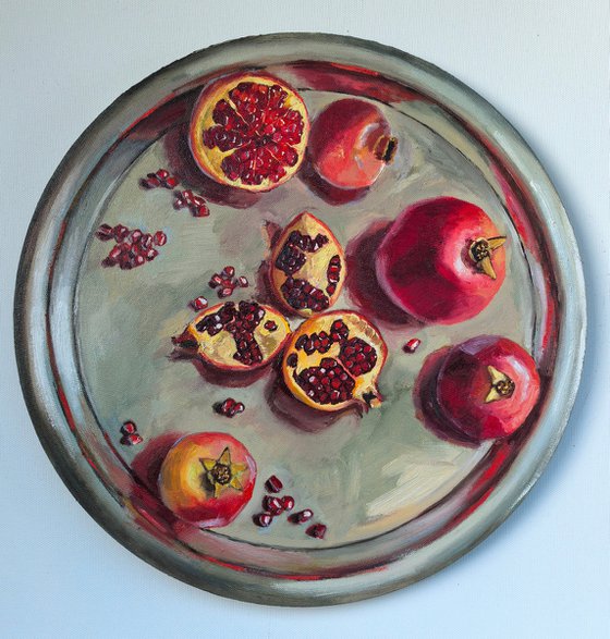 Pomegranates on metal try