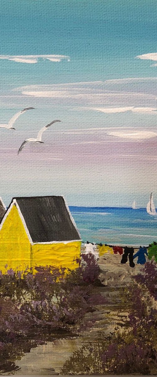 Three beach huts on the beach by Marja Brown