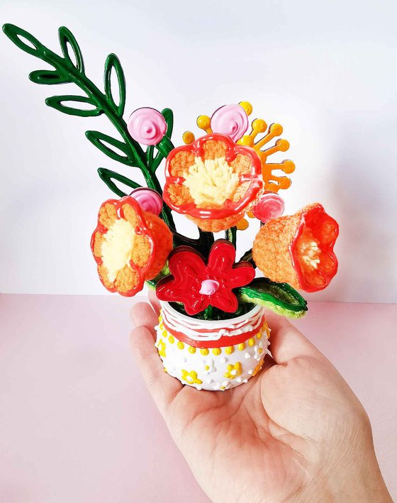 Orange crochet flowers in vase