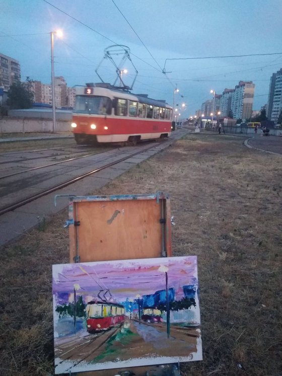 Streetcars in the evening city. Pleinair painting