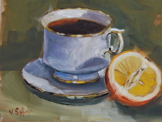 Teacup and orange. still life