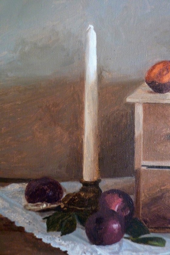 Plums, candle and books