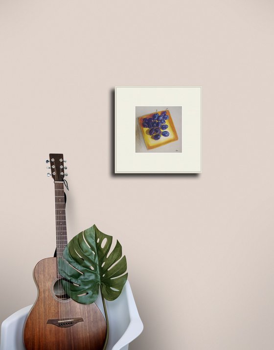 Blue plums on a yellow dish