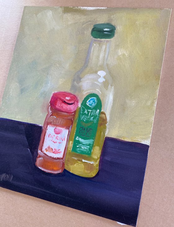 Still life with a bottle of olive oil and paprika