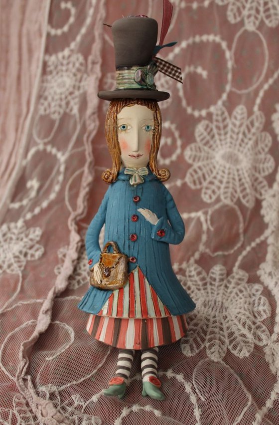 Vintage dressed girl with a handbag. Small ceramic sculpture, bell-doll