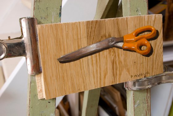 scissors on parquet plank