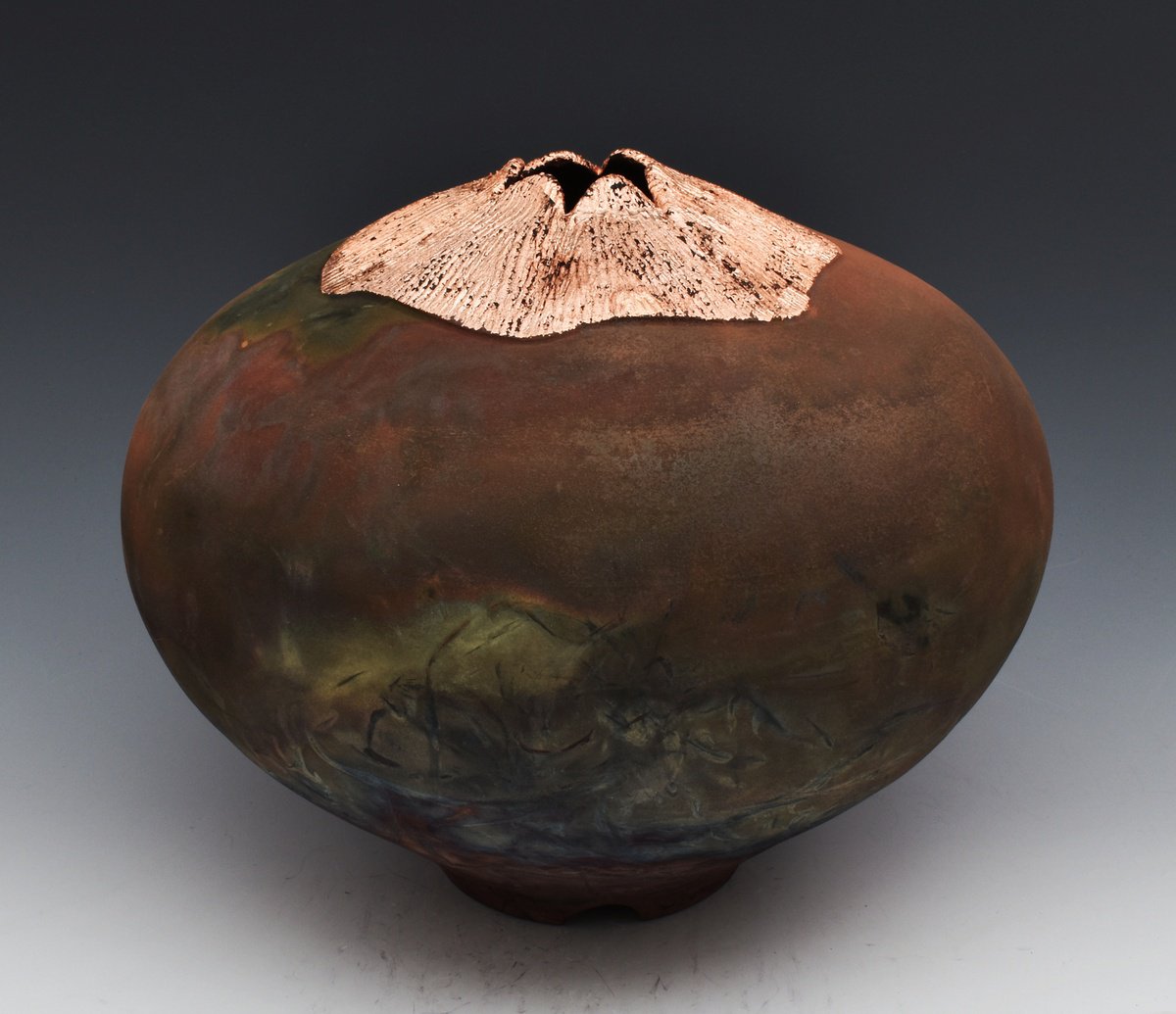 Stoneware vessel, raku fired, carved with copper leaf. one of a kind M611 by Ron Mello
