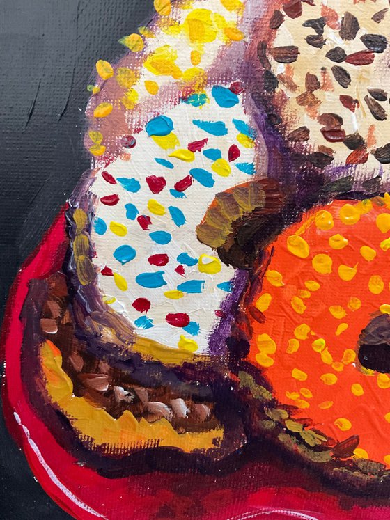 Colourful donuts in red dish