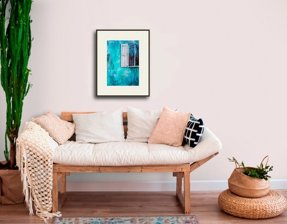 A window in a turquoise wall