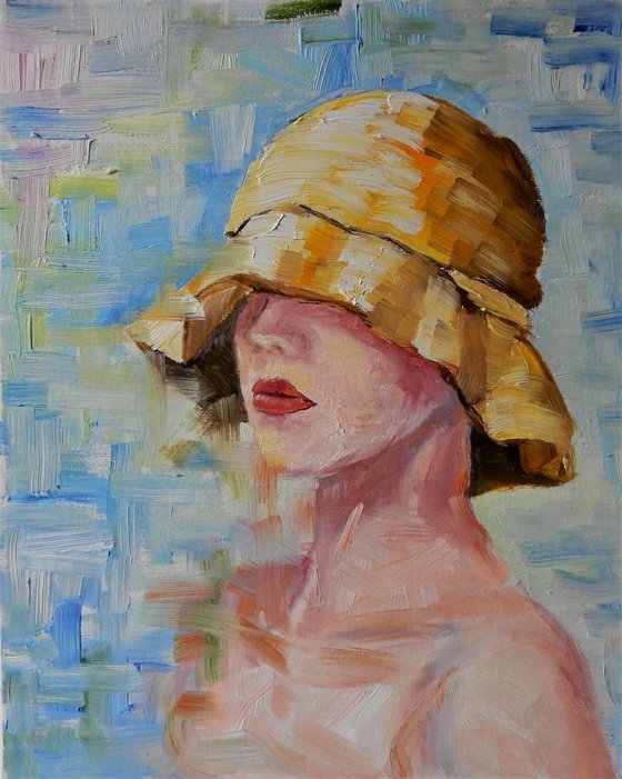 Portrait. Young lady in a yellow summer hat.