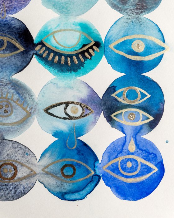 Gold leaf eyes on blue watercolor background