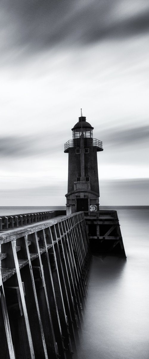 A lighthouse at the port by Karim Carella